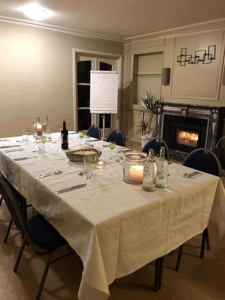 Big room with festive dinner in front of fireplace